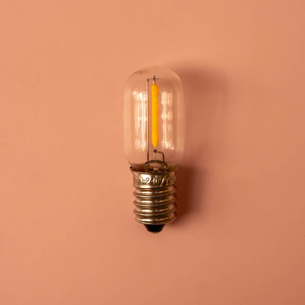 Clear light bulb on a pink background
