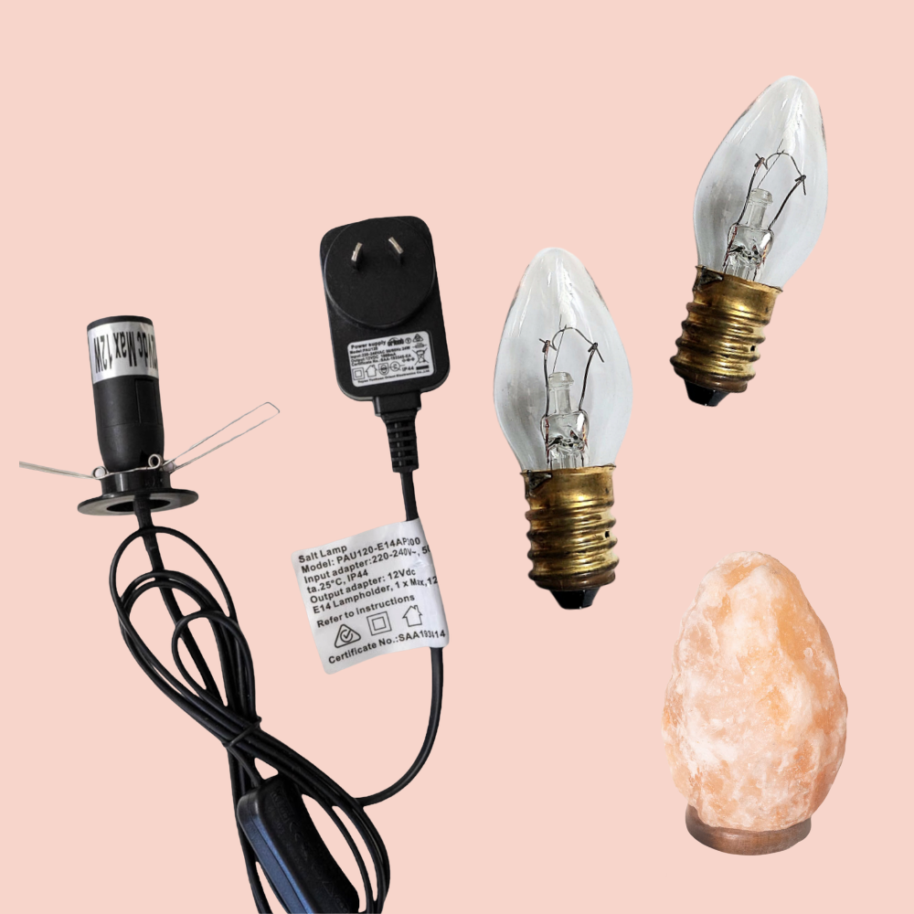12V - 12W Light bulb, 12V DC plug adapter, and salt lamp on a pink background
