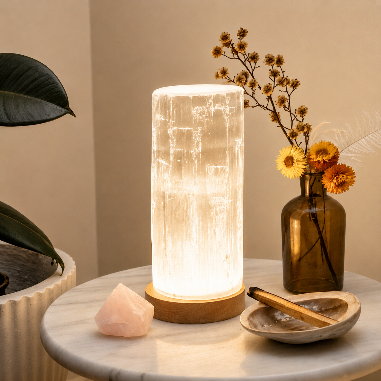 Luminescent Selenite crystal lamp on a marble surface with decorative elements.