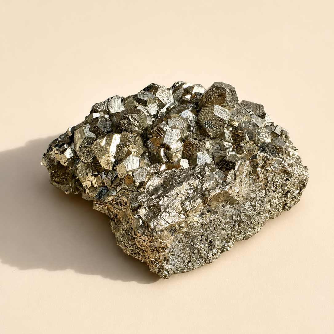 Pyrite Mineral specimen on a beige background