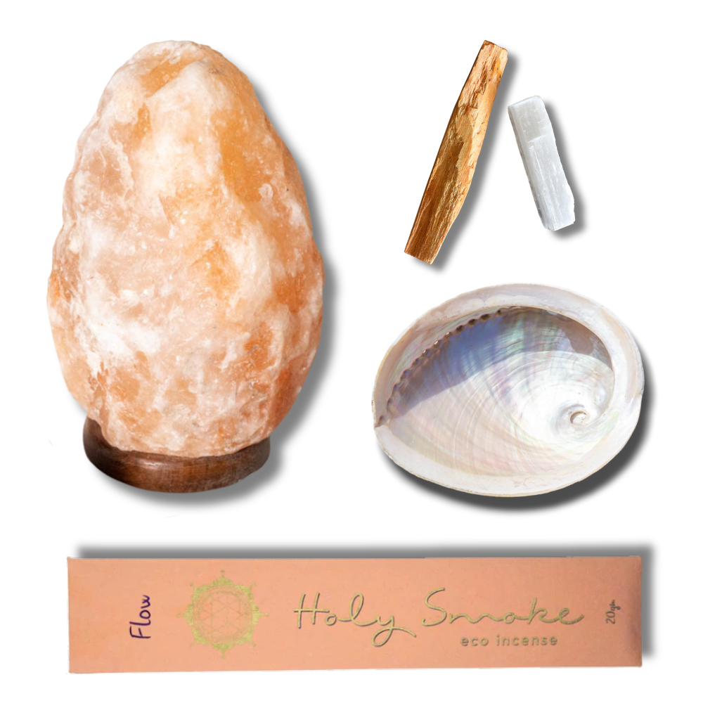 Himalayan salt lamp, shell, wooden tool, and incense packaging on a white background
