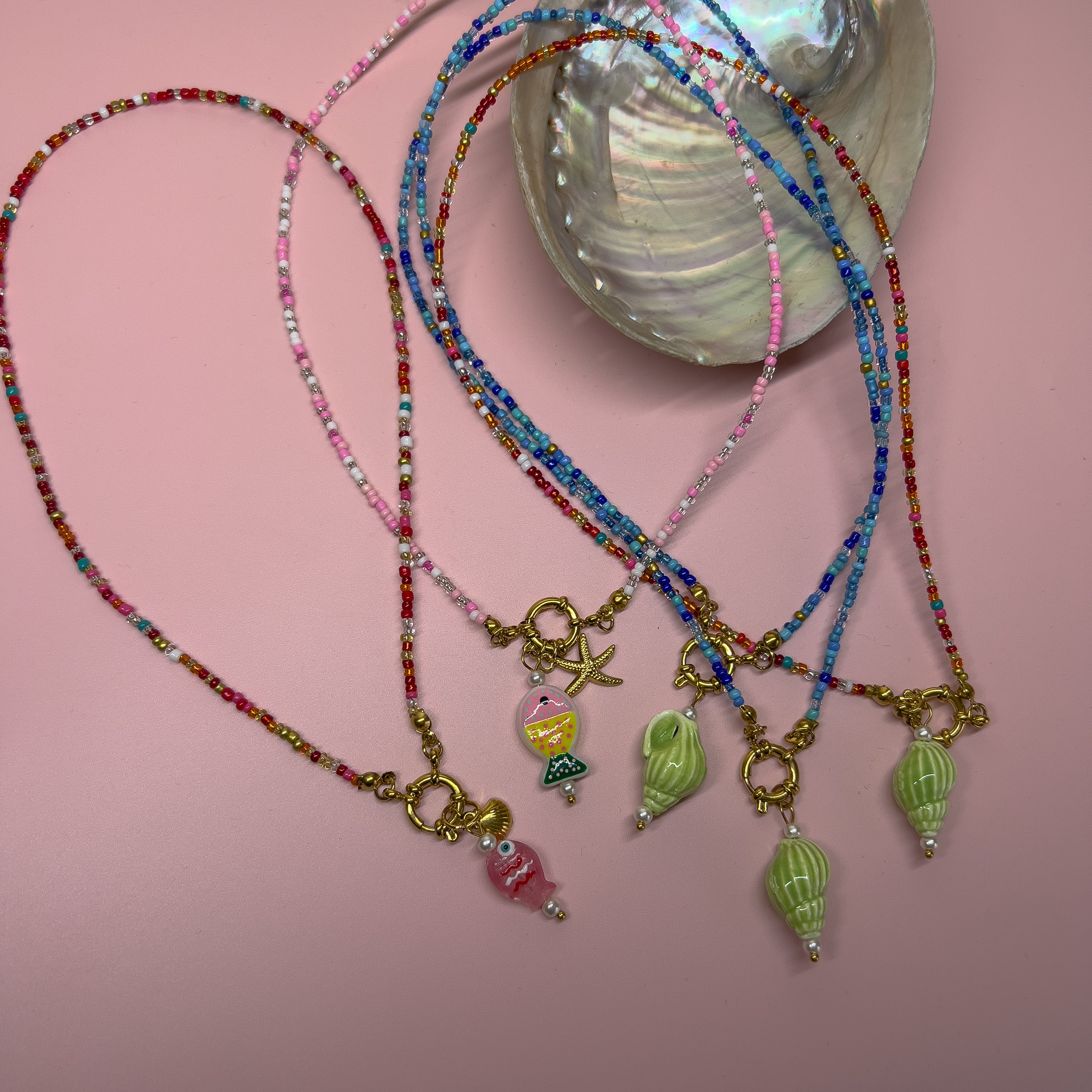 Beaded charm necklaces in shell and fish designs 