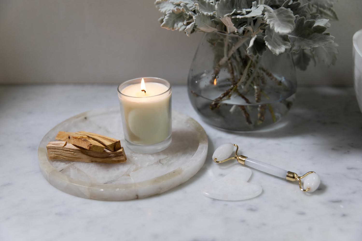 Face roller in bathroom with candle