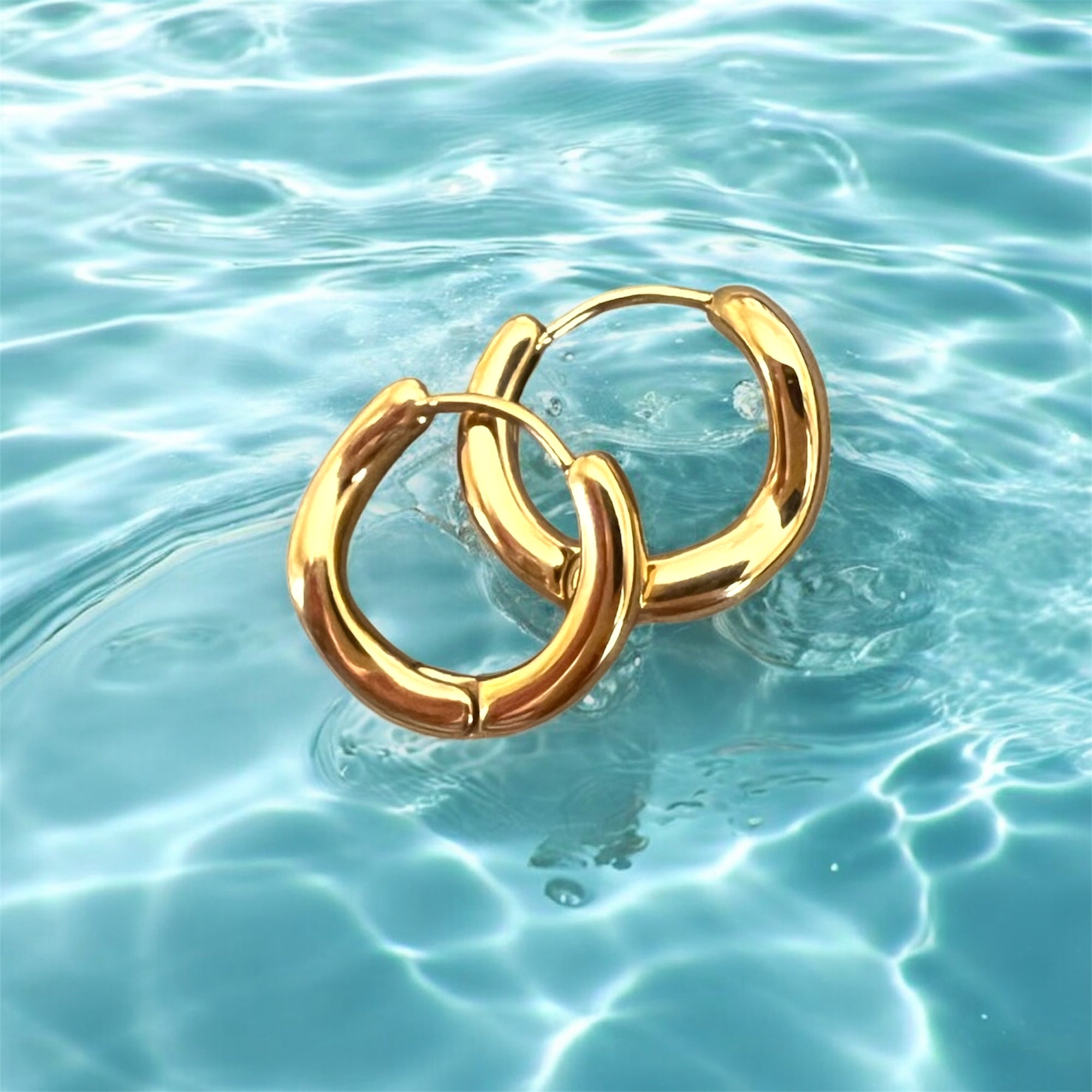 Gold wavey hoops on water 