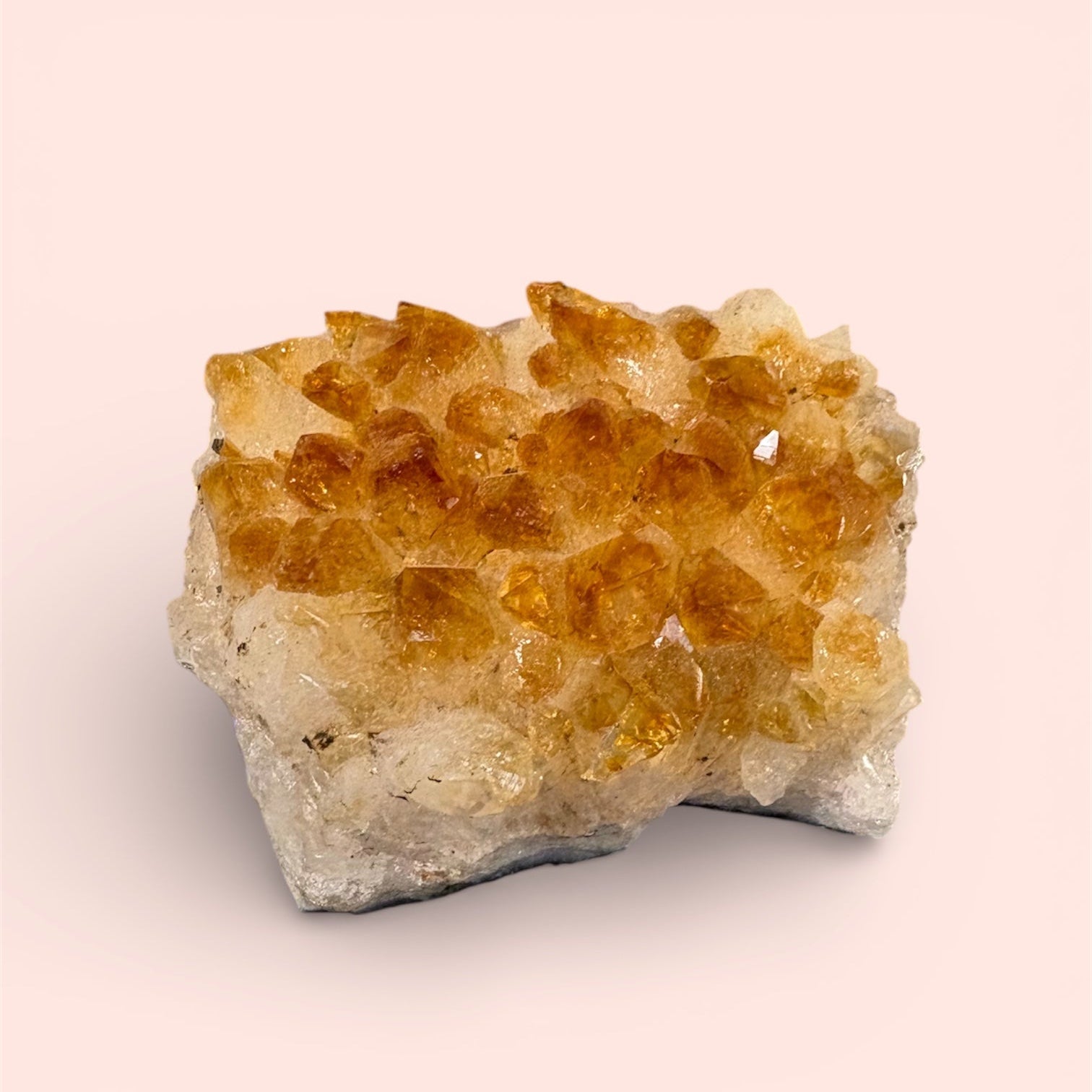 Citrine crystal cluster on a beige background