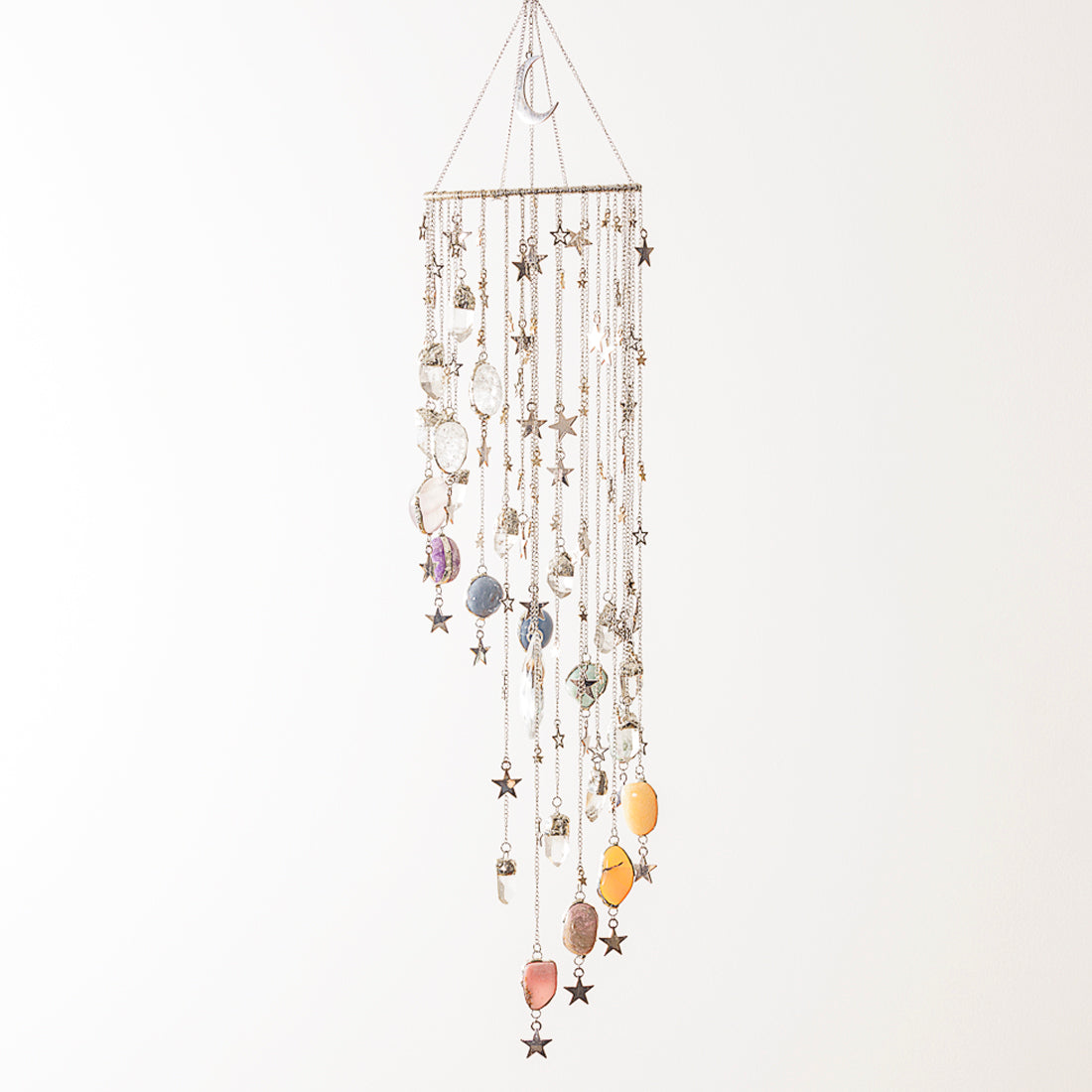 Decorative crystal hanging mobile with stars and colourful stones on a white background