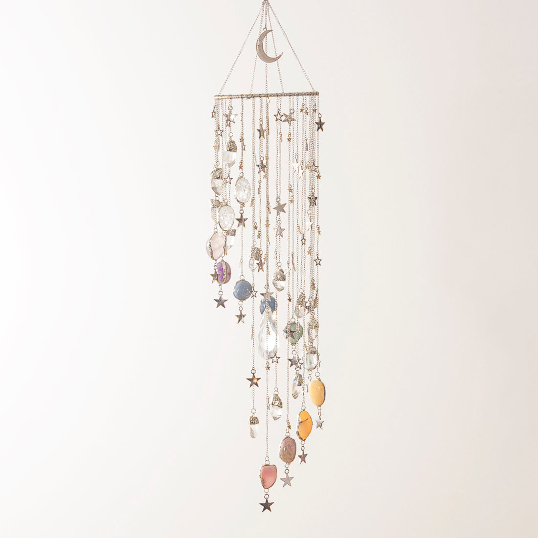 Decorative hanging mobile with stars and moons on a plain background