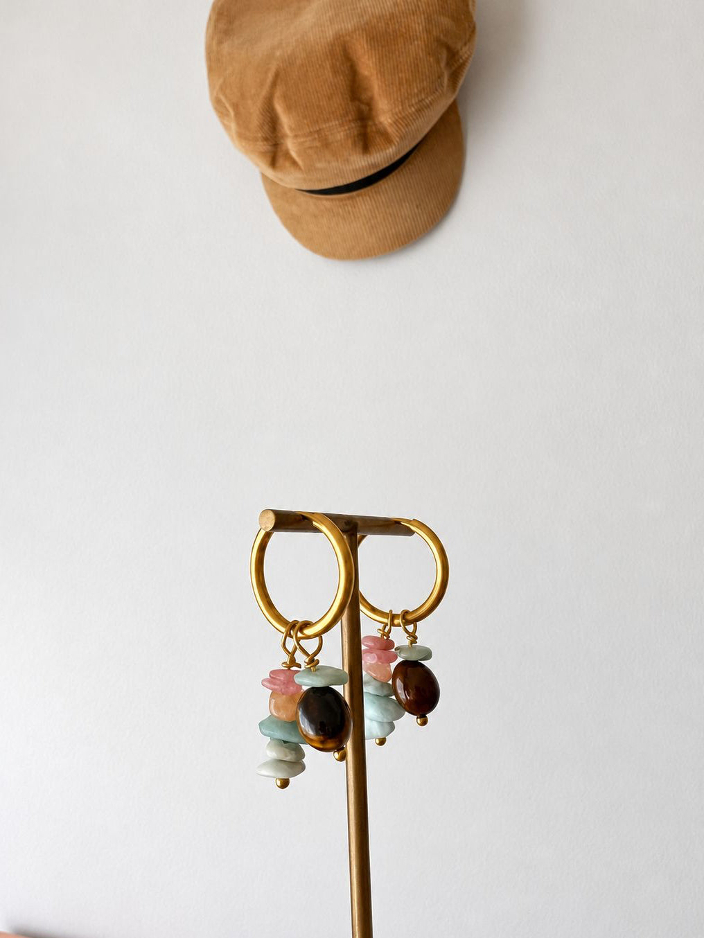 The wanderer crystal hoops on earring stand 