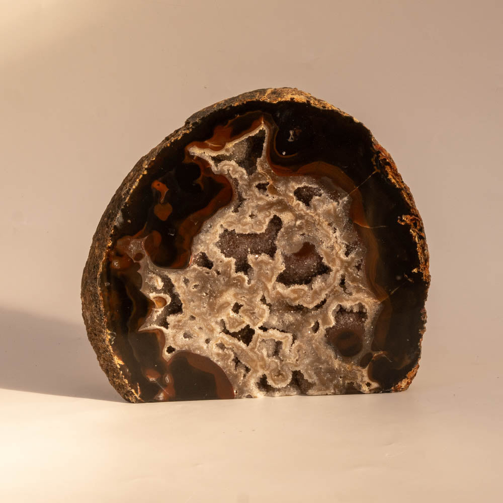 Geode with agate patterns on a beige background