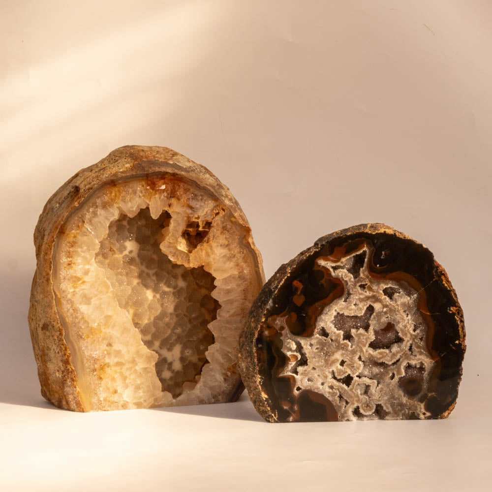 Two geode crystals on a beige background