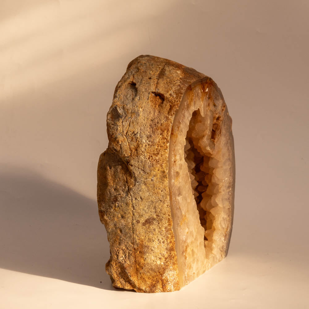 Geode with a rough exterior on a beige background