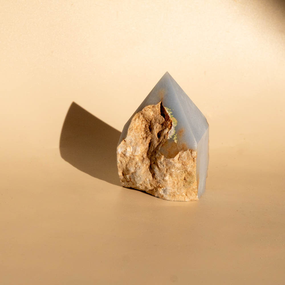 Angelite Top Polished Crystal Generator on beige background