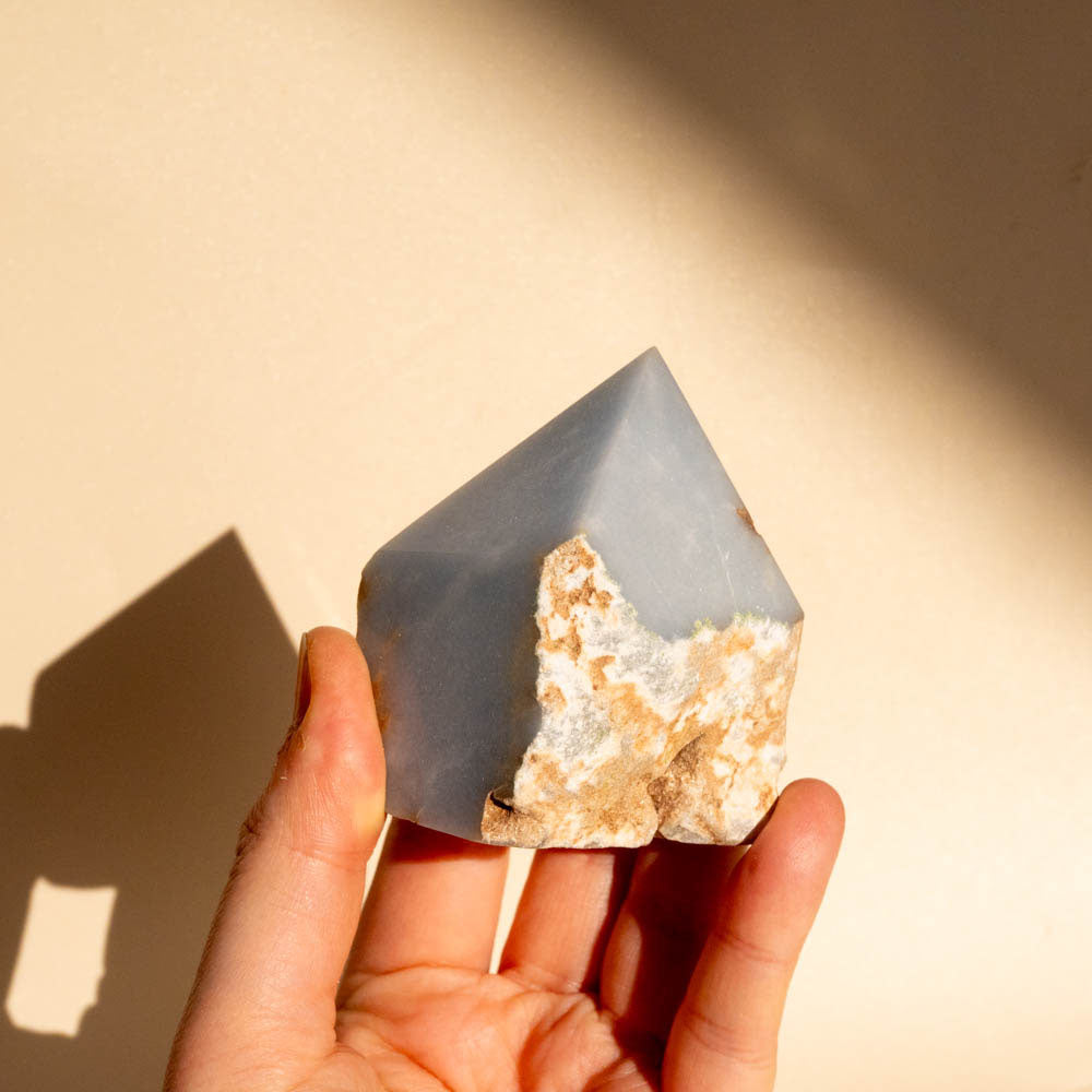 Angelite Top Polished Crystal Generator on beige background