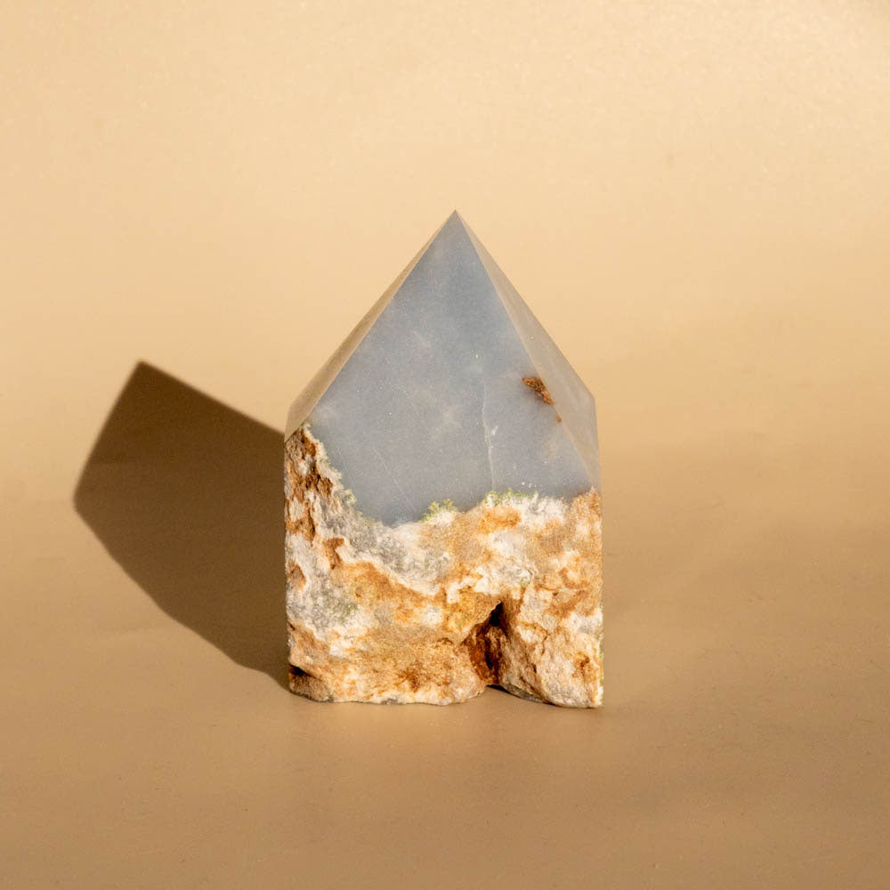 Angelite Top Polished Crystal Generator on beige background