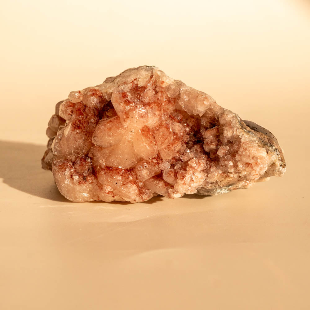 Pink Amethyst crystal rock on a beige background