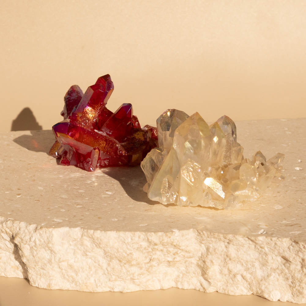 Ruby Aura crystal cluster on a beige surface