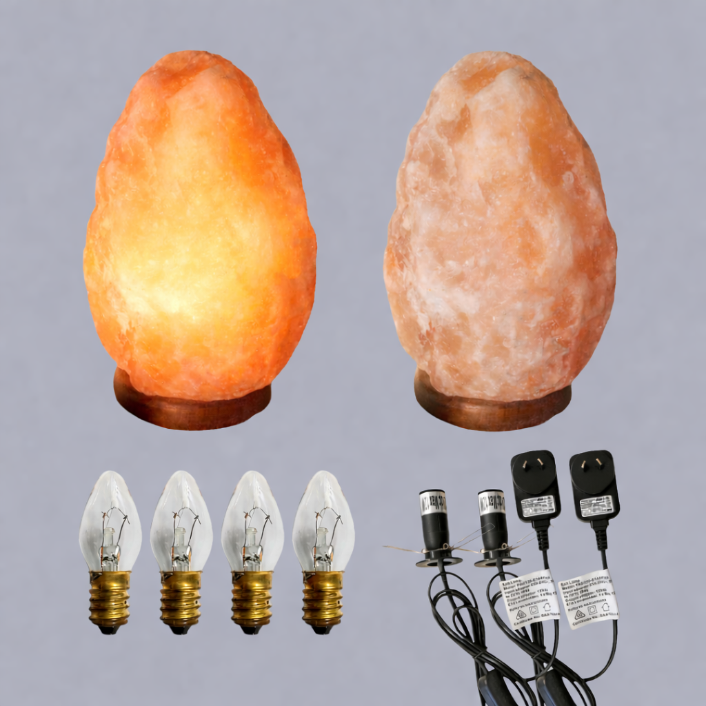 Two Himalayan salt lamps with light bulbs and power plugs on a gray background