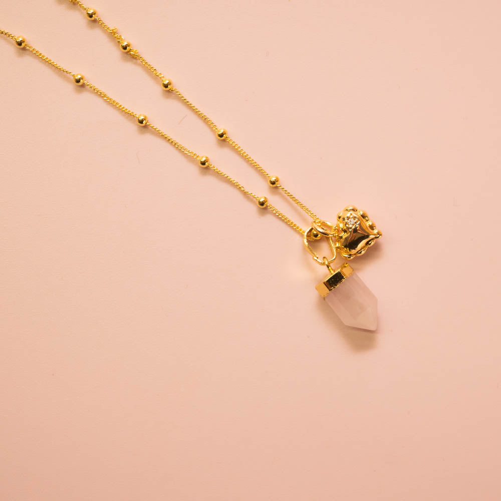 Rose quartz point crystal pendant and heart charm on gold ball chain
