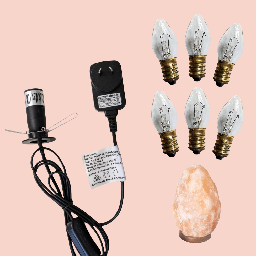 12V - 12W Light bulb, 12V DC plug adapter, and salt lamp on a pink background