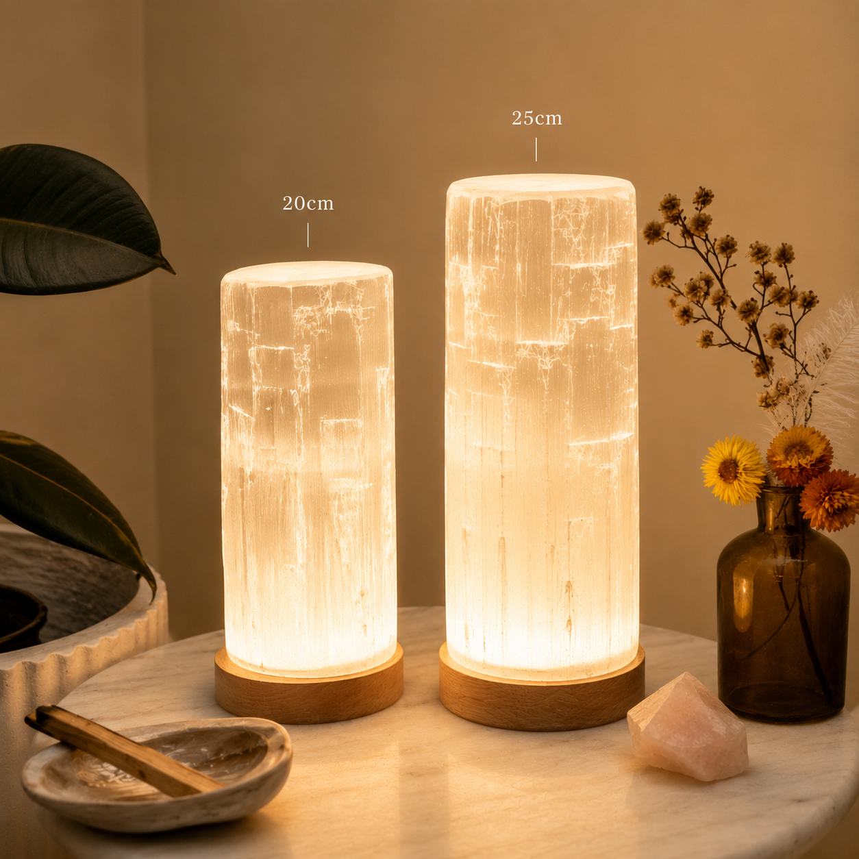 Two Selenite crystal lamps on a table with measurements and decorative items.