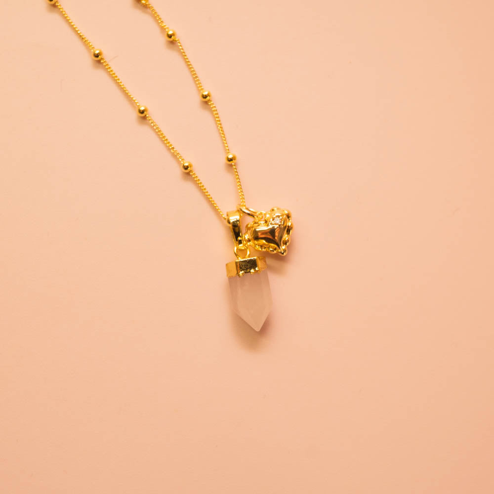 Rose quartz point crystal pendant and heart charm on gold ball chain
