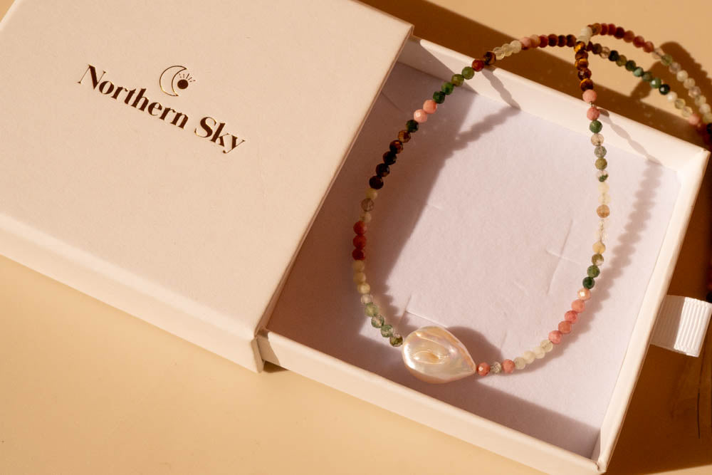 grounding pearl necklace in box