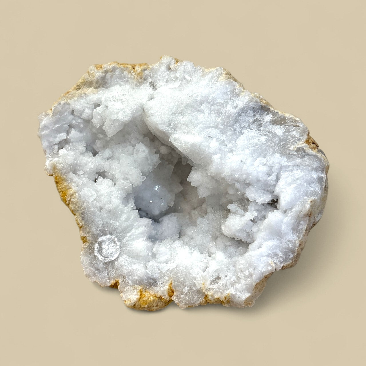 Geode with crystal formation on a beige background