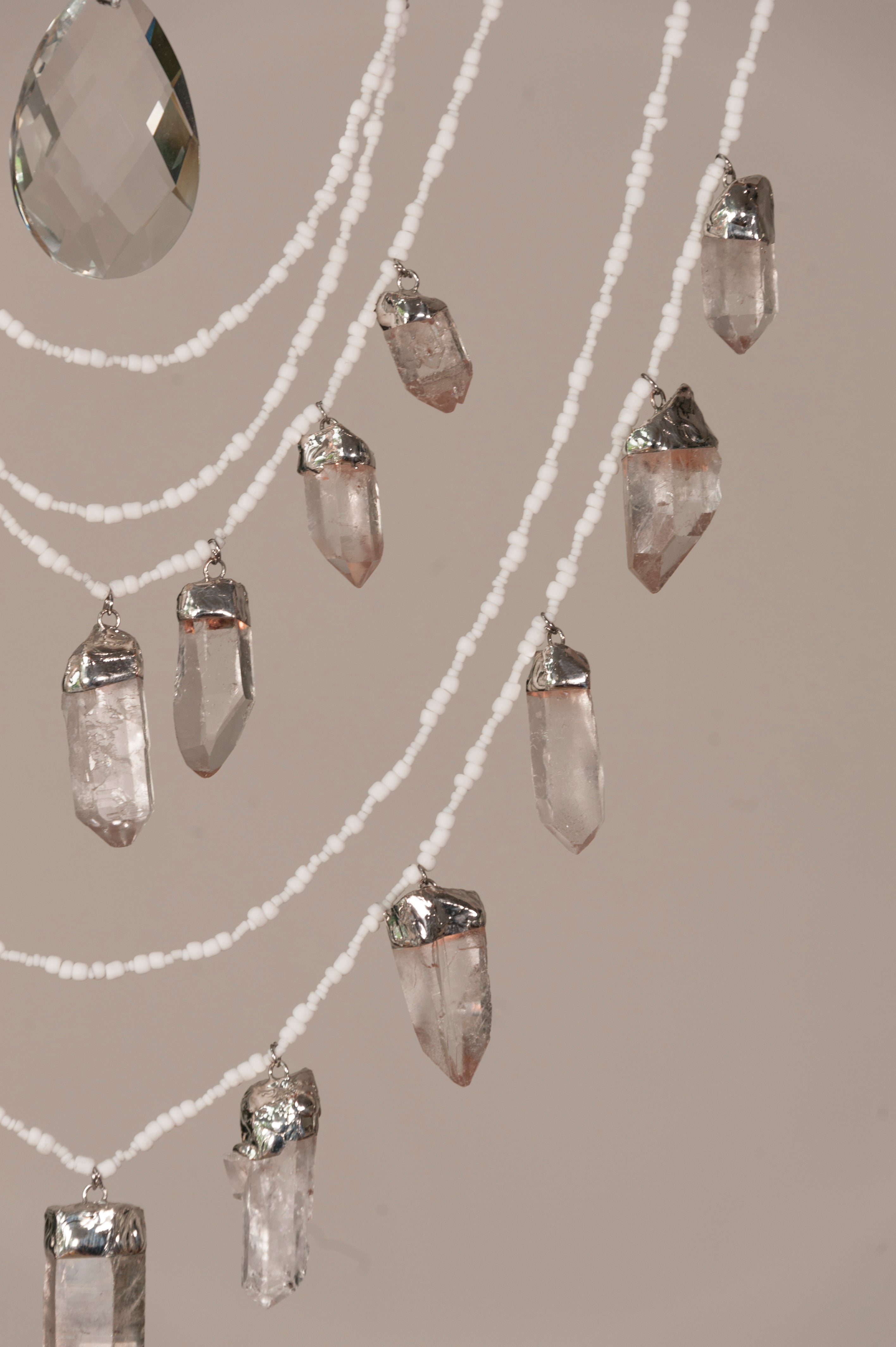 Crystal chandelier with hanging crystals on a neutral background