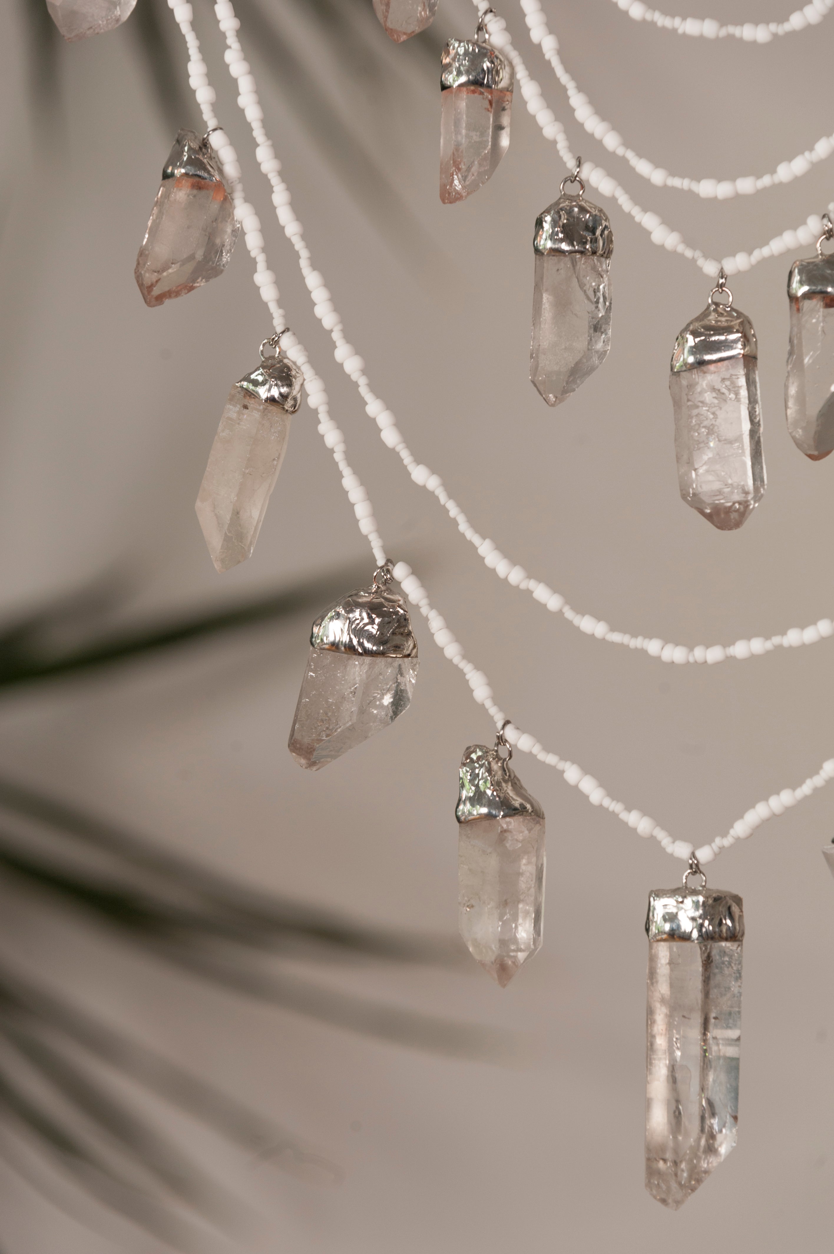 Crystal pendant necklace on a neutral background