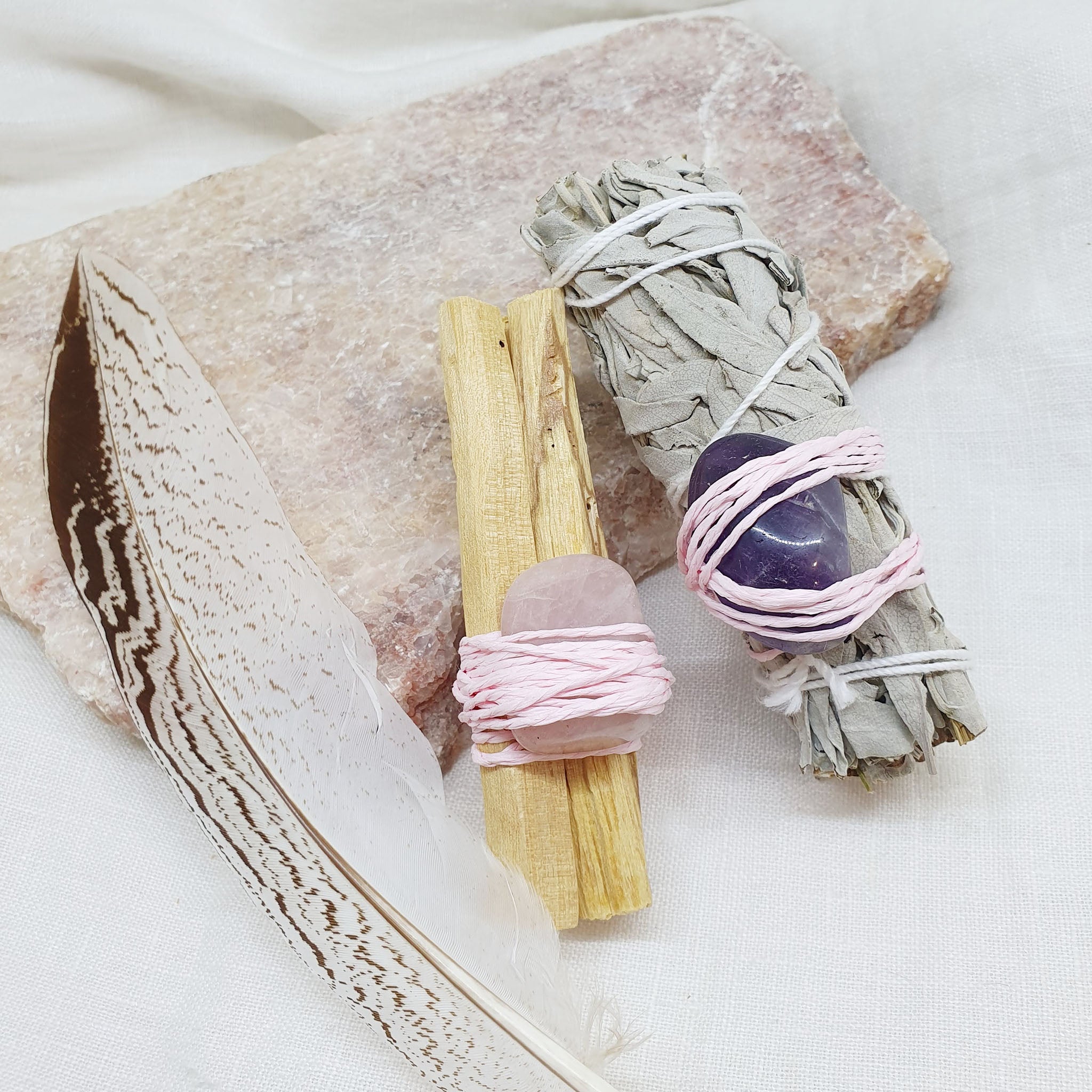 white sage amethyst and palo santo rose quartz with feather