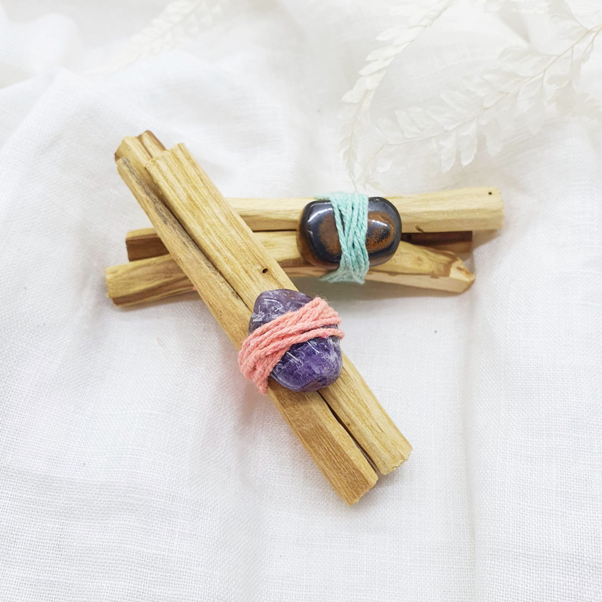 palo santo smudge sticks with tiger's eye and amethyst gemstones